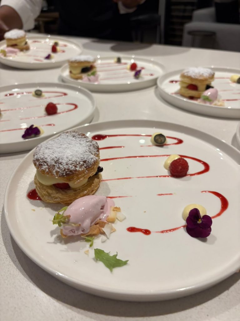 Layered pastry dessert with sorbet and berry coulis