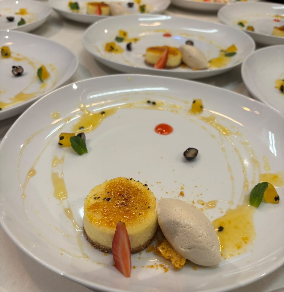 Creme brulee with a sorbet quenelle, plated for service